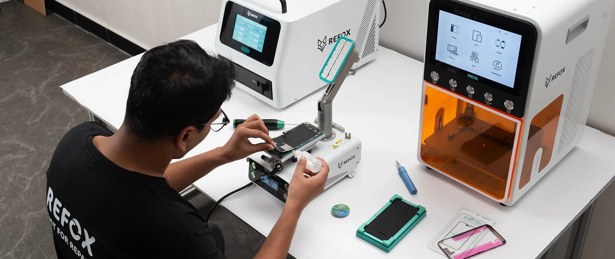 a person repairing phone using refox tools and machines