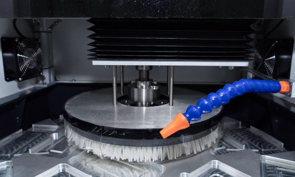 Close-up of a refox polishing machine with a blue and orange hose