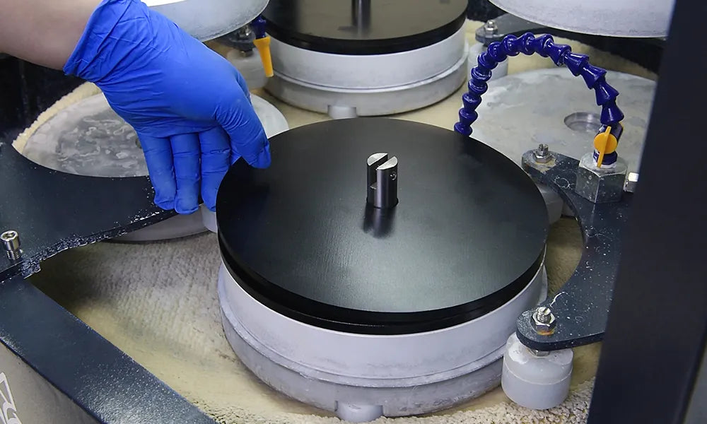 Person wearing blue gloves operating ap38 machine