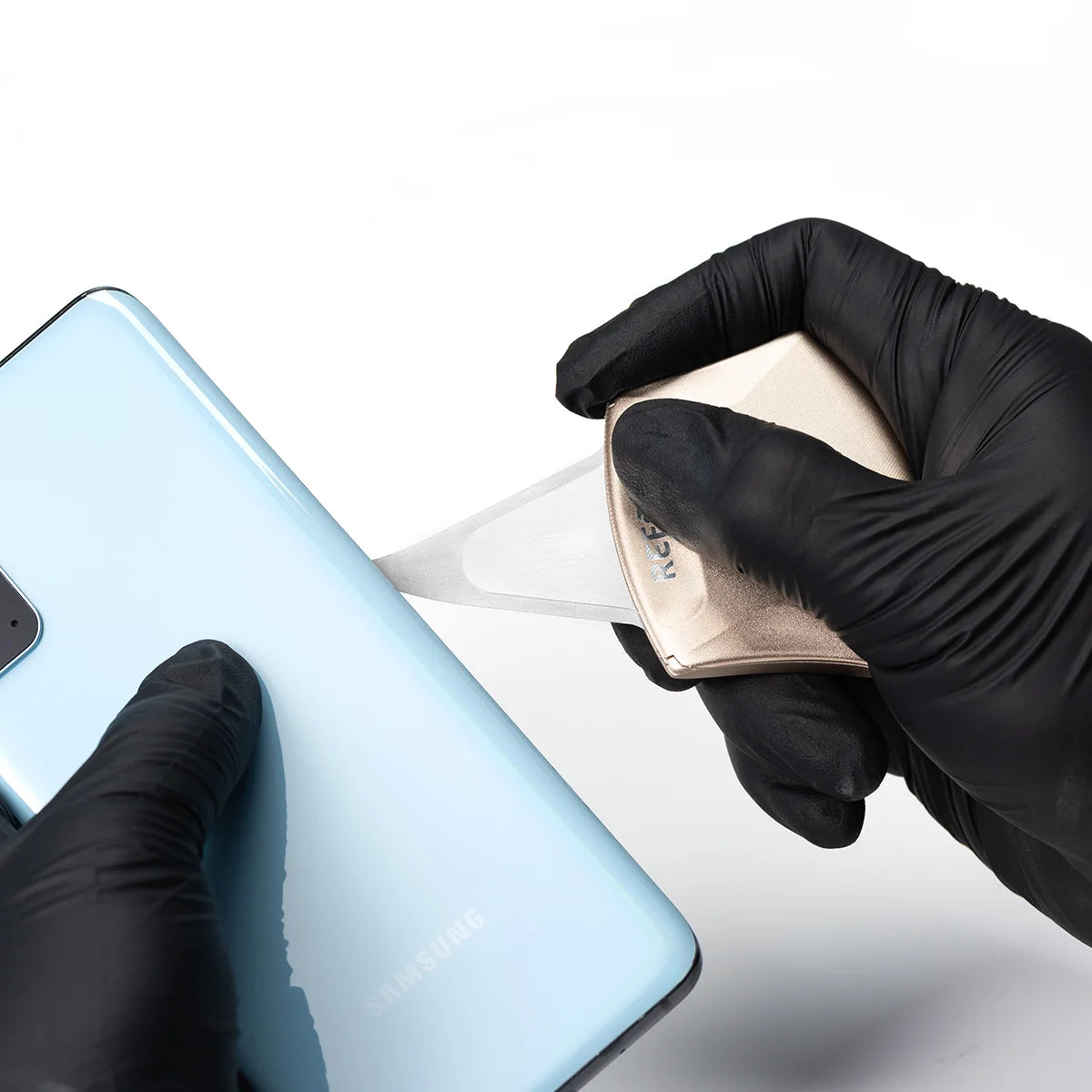 person wearing a glove using rs70 pry tool opening a Samsung phone