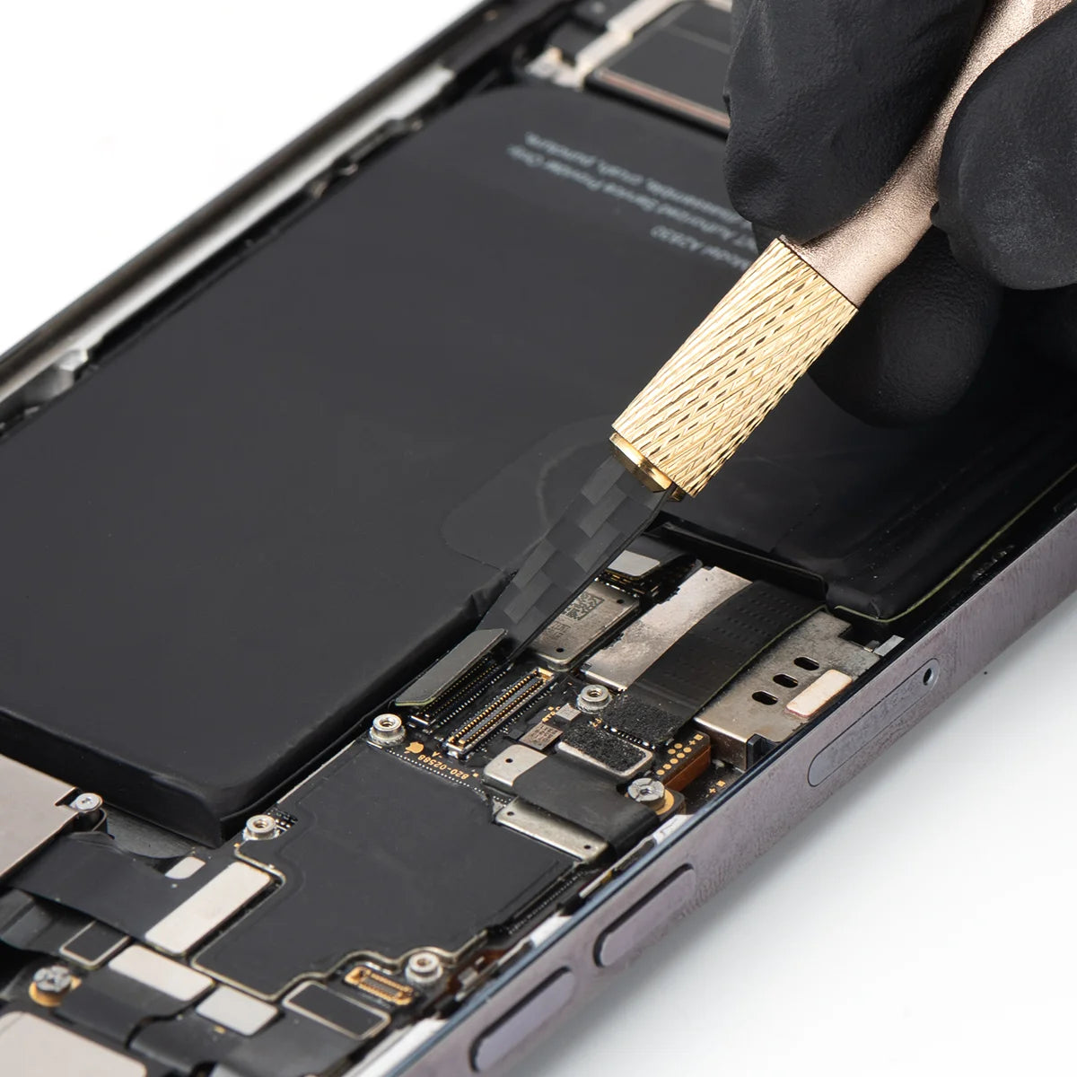 Close-up of a smartphone's internal components with a refox knife being used.