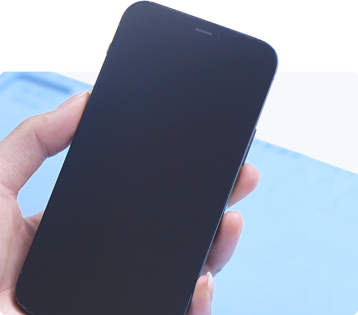 Hand holding a black smartphone with a blurred blue background