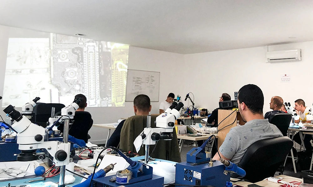 Classroom setting with students using microscopes in a laboratory.