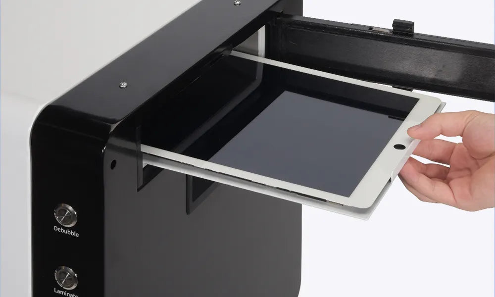 Hand placing a tablet screen on a fm50 machine