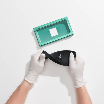 Person wearing gloves holding a black foam of a refox alignment mold