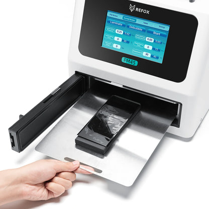 REFOX FM45 device with a screen displaying software interface, being used to process a smartphone.