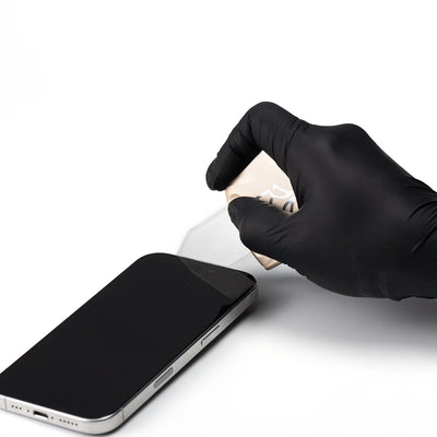 Hand wearing a black glove cleaning a smartphone screen on a white background