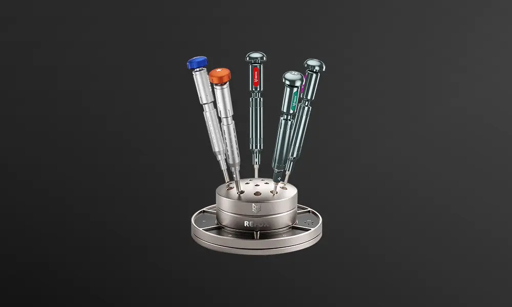 Set of colorful screwdrivers on a stand against a black background